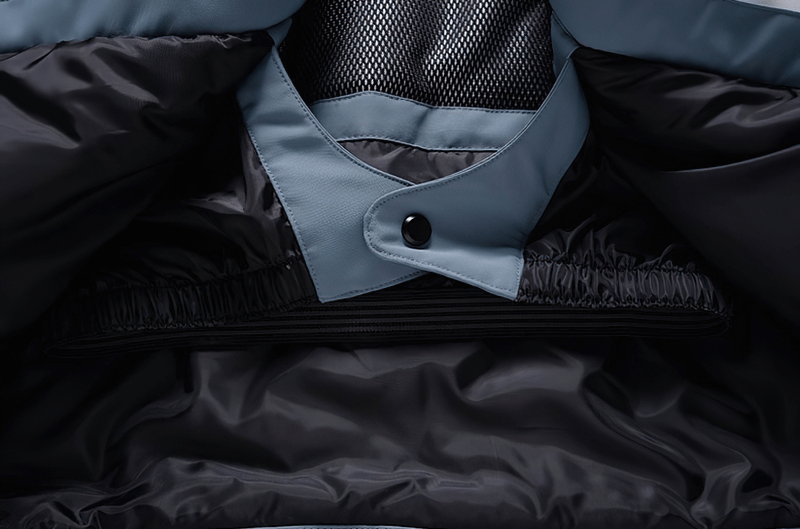 Interior view of a warm waterproof snowboarding jacket with hooded collar and black lining, featuring an elastic waist and snap closure.
